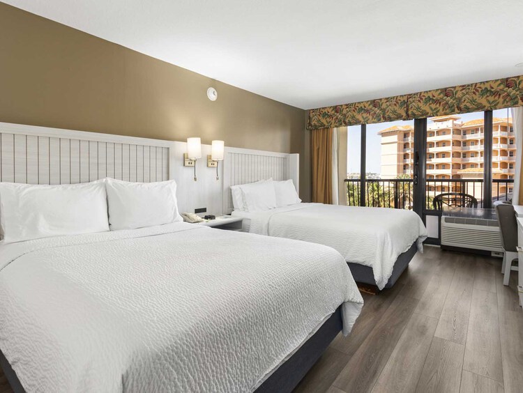 Two queen beds and a balcony
