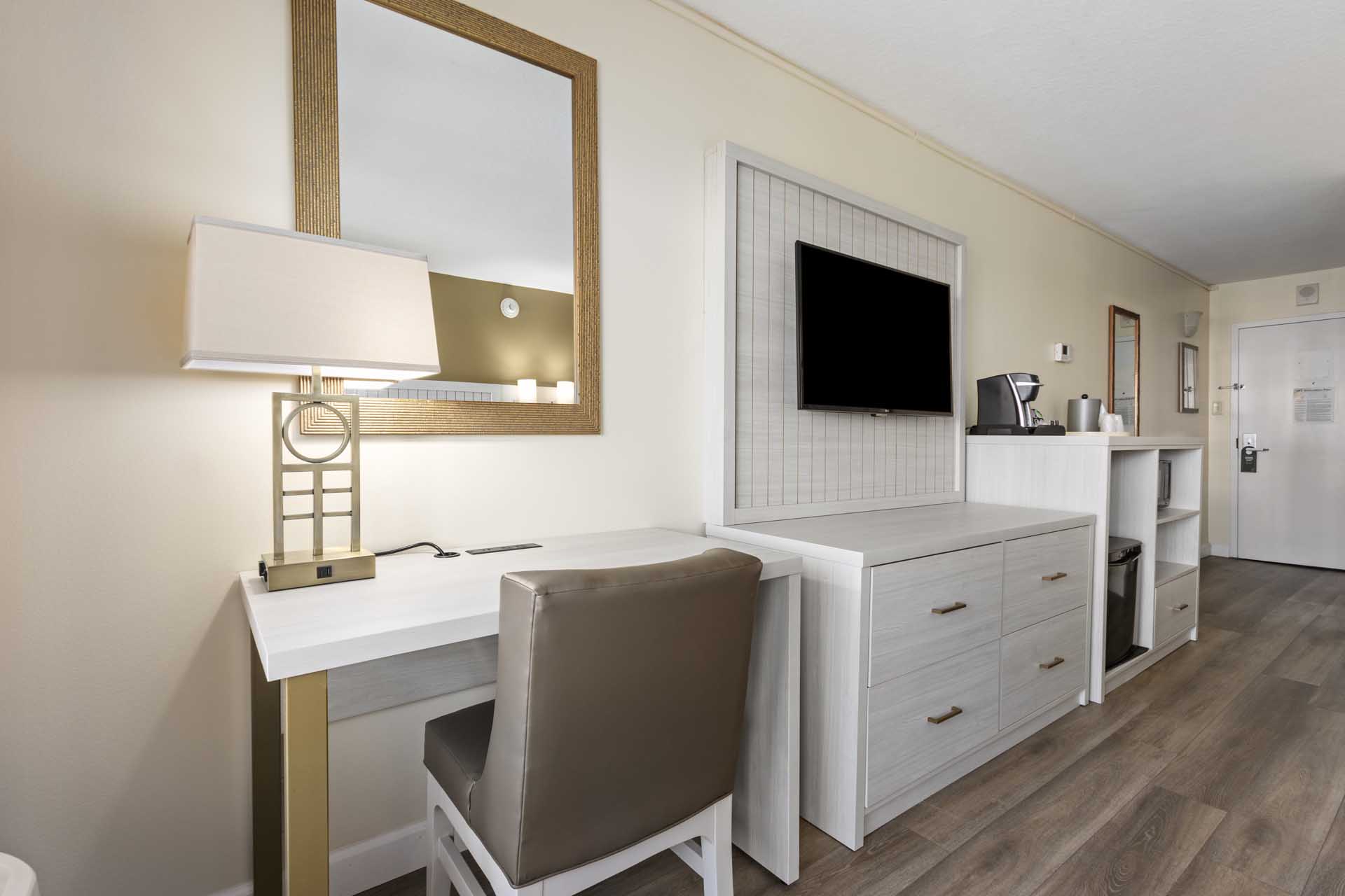 Guest room with a desk and TV